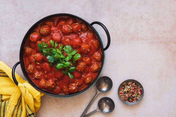 Meatballs in rich tomato sauce in cast iron pot