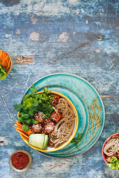 istock Thai curry meatballs noodle bowl with green vegetables and herbs 960353666