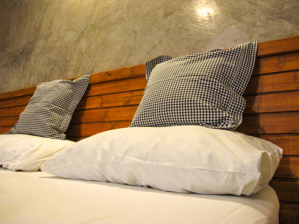 istock Throw Pillows and pillow on White bed in bedroom interior 960357012