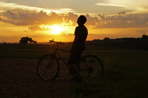 istock A man on a bicycle contemplating the sunset 960360026