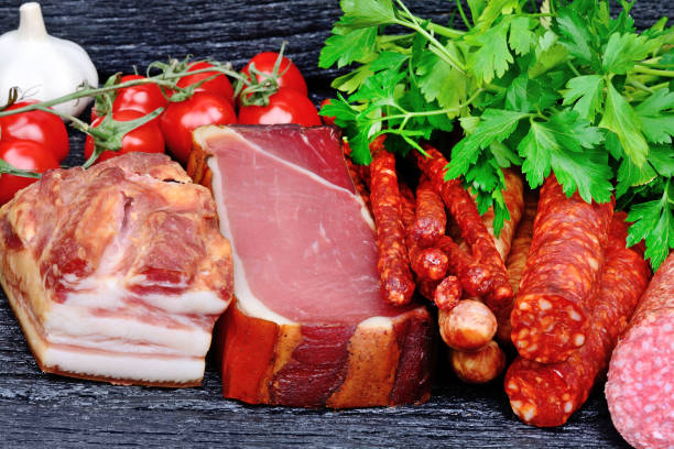 istock Sausages with cherry tomatoes, parsley and garlic on table 960369940