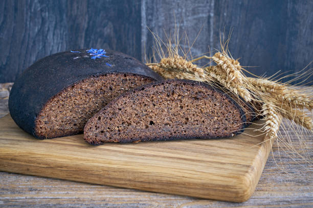 istock Fresh sliced whole grain rye bread loaf on wooden cutting board. Copy space. 960380580