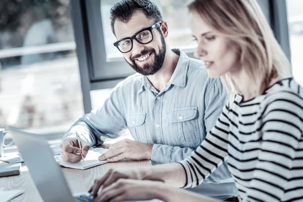 istock Joyful bespectacled man writing and smiling 960389080