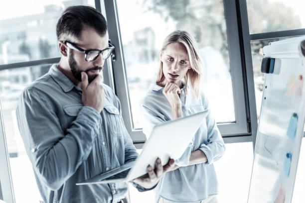 istock Serious thoughtful employees using the laptop and thinking 960393744