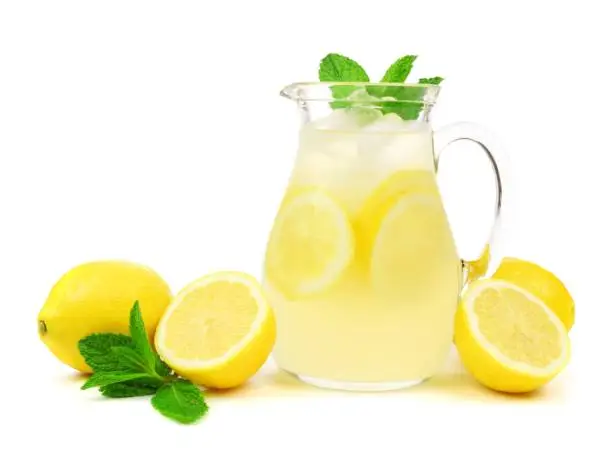 Photo of Jug of lemonade with lemons and mint isolated on white