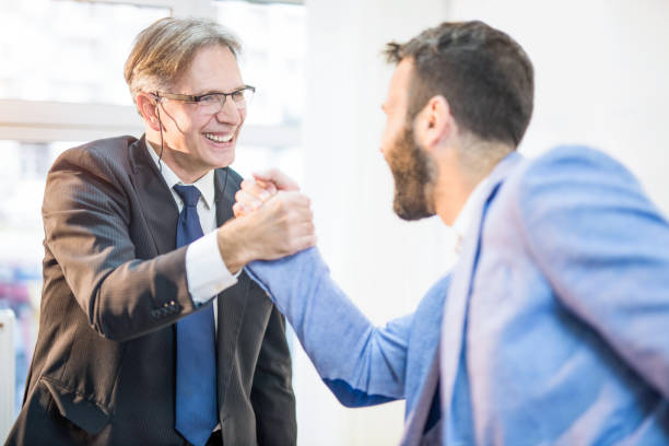 istock Two excited businessman shaking hands. 960413304