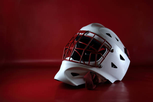 Hockey goalie wearing a vintage goalie mask