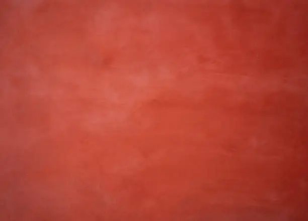 Red painted wall background with washed-out color