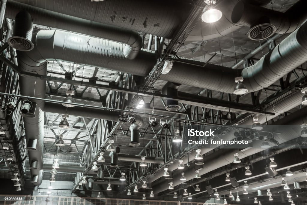 HVAC Duct Cleaning, Ventilation pipes in silver insulation material hanging from the ceiling inside new building. Air Duct Stock Photo