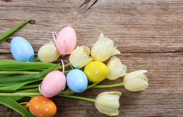 istock Easter eggs and tulips on a wooden table 960443922