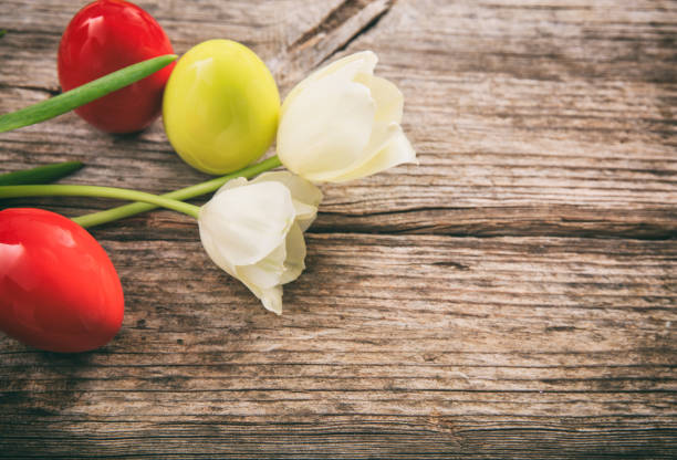 Easter eggs and tulips on a wooden table