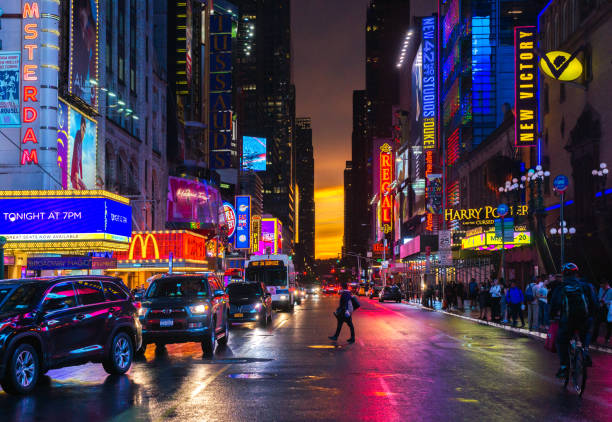 New York 42nd Street in Colorful Theatre Lights with Orange Sunset Background stock photo
