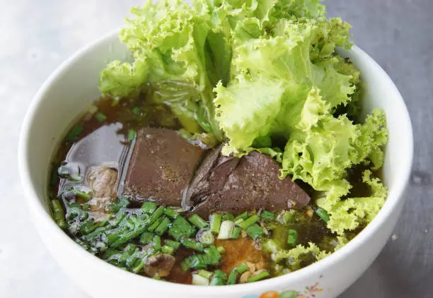 Photo of Pork blood cubes soup in bowl, delicious breakfast of Thailand