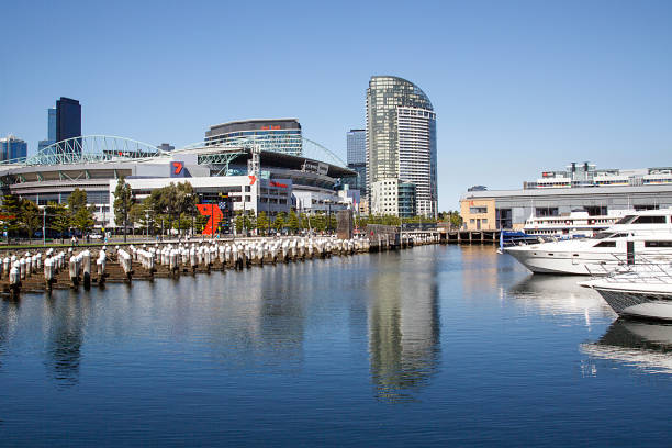 Melbourne, Australia: April 07, 2018: Luxury motorboats and motor yachts are moored in Melbourne Docklands. The marina is overlooked by 7 Melbourne television studio and Etihad Stadium.