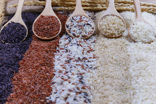 Five kinds of rice on wooden spoon.