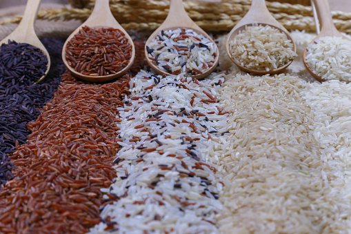 Five kinds of rice on wooden spoon.