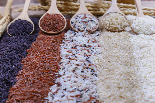 Five kinds of rice on wooden spoon.