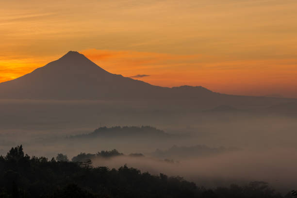 istock Shadow of mountain before sunrise surrounded by fog 960458606