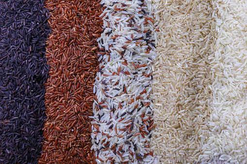 Food background with top view of five rows of rice.