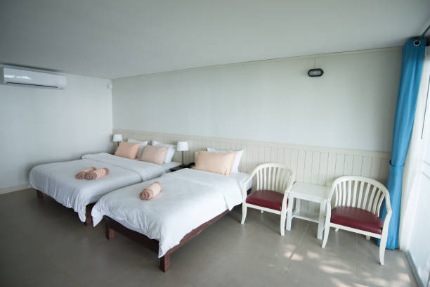 istock Interior in hotel room including bed with pillow, towels, table and chair 960459032