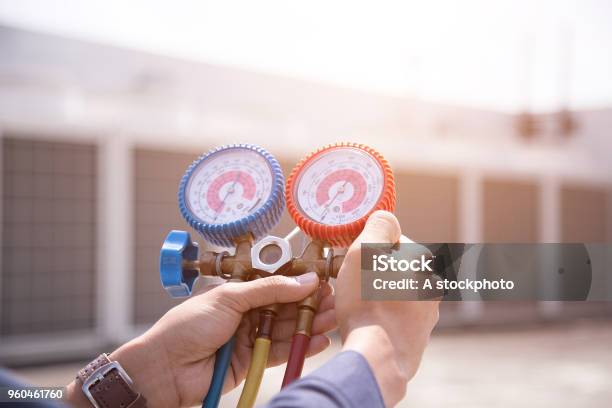 Technician Is Checking Air Conditioner Measuring Equipment For Filling Air Conditioners Stock Photo - Download Image Now