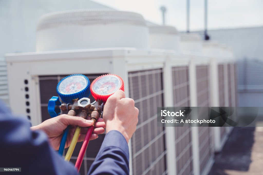 Technician is checking air conditioner ,measuring equipment for filling air conditioners. Air Conditioner Stock Photo