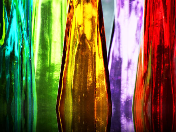 Colorful glass bottles Different colored glass bottles, vases, backlit with natural light murano stock pictures, royalty-free photos & images