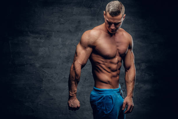 istock Muscular young man isolated with contrast illumination. 960465832