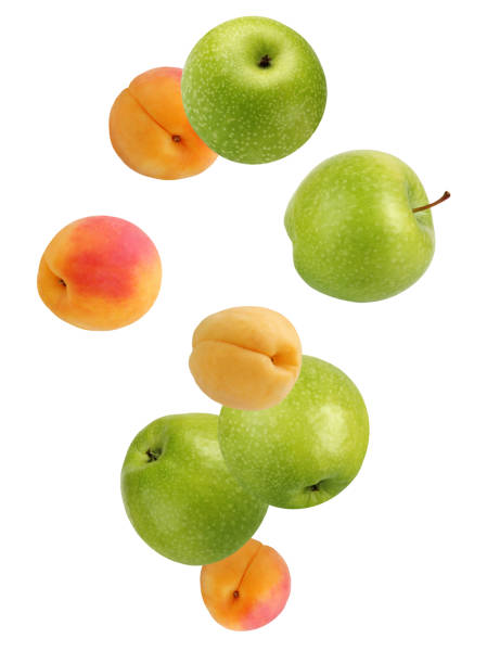 istock Falling apples and apricots isolated on white background. 960470146