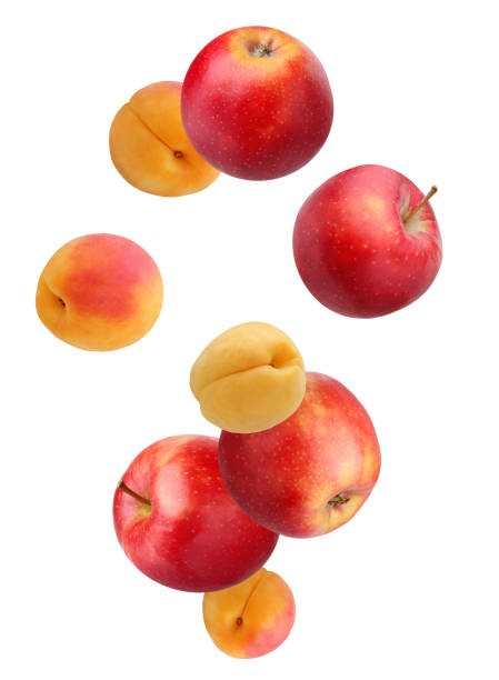 istock Falling fruit: apples and apricots isolated on white background. 960470264