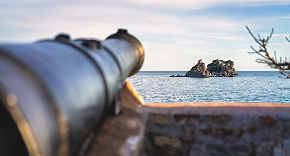 Medieval cannon gun directed on the old Monastery,  walls of the old Petrovac old town fortress, Montenegro