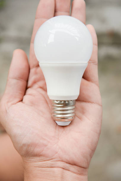 istock LED bulb in human hand for energy saving concept 960471368