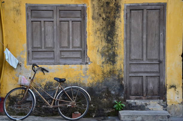 istock old bicycle on yellow wall of building 960472336