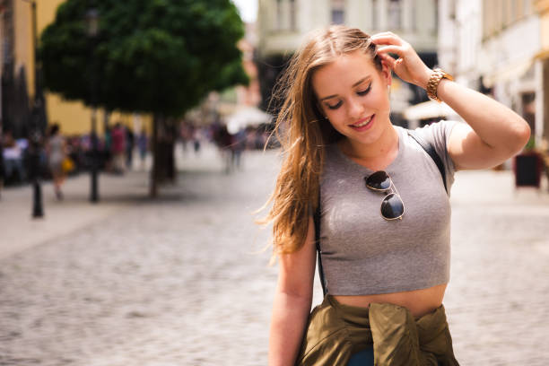 Beautiful woman walking outside through the shopping center.