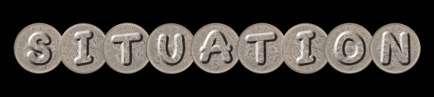 istock SITUATION written with old British coins on black background 960478650