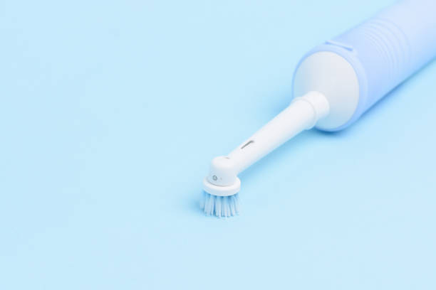 istock An electric toothbrush isolated on light blue background. 960479188