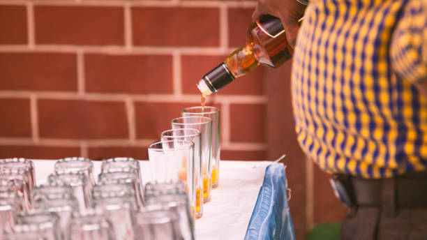 istock Bar tender is pouring whiskey into glasses in Punjabi wedding 960479814