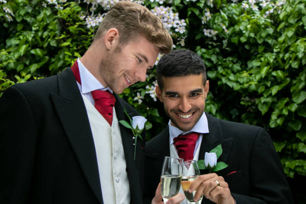 istock Gay couple at wedding reception toast being married 960479952