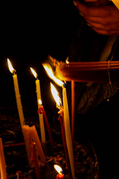 Lighting candles in the Church of the Holy Sepulcher in the Old City of Jerusalem