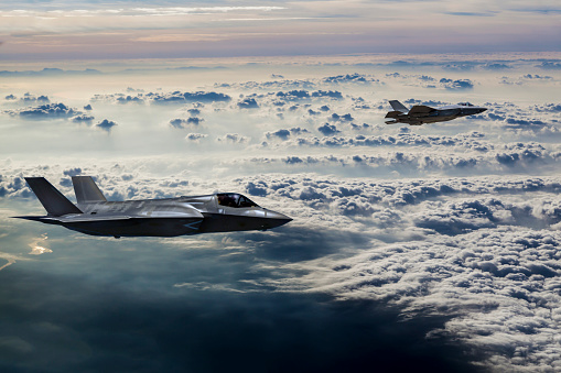 Fighter Jets flying over the misty mountains at dusk