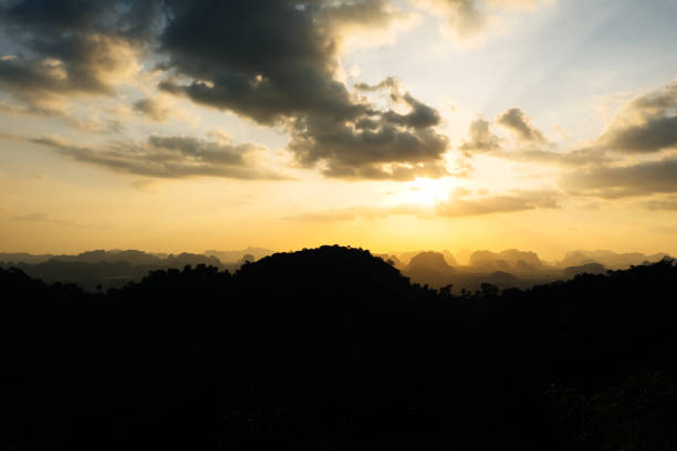 istock Silhouette of mountain and orange summer sunset background. 960484120