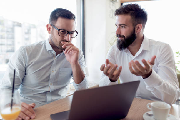 istock Two businessmen are working in cafe 960484432