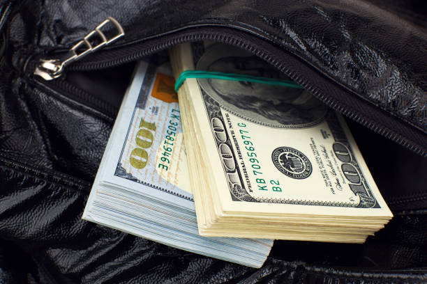 istock American dollars in black handbag 960487790