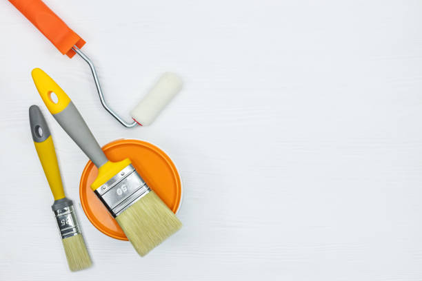 istock house renovation tools - brushes, paint, rollers on white wooden desk 960487932