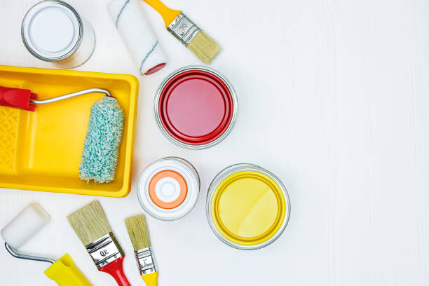 istock painting tools on white wooden background. flat view 960489734
