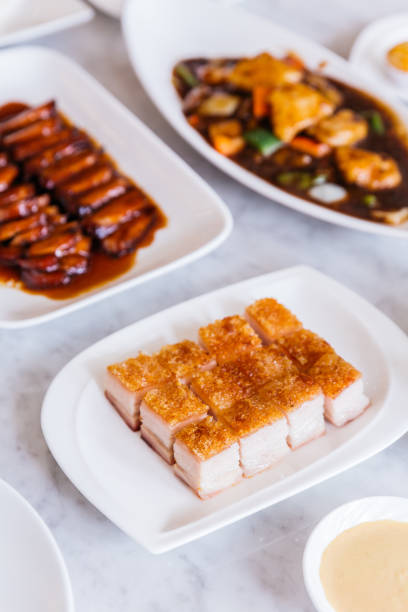 istock Close up Golden Crispy Pork Belly cut in cube served in white plate. 960492582