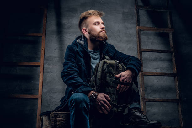 istock The bearded backpacker male sits on a wooden box. 960496662