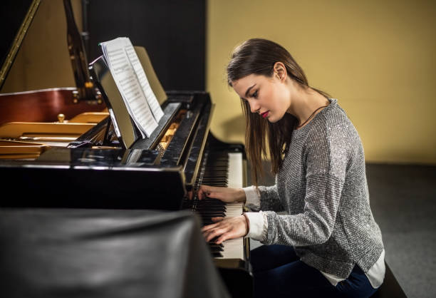 istock Young woman playing the grand piano 960496866