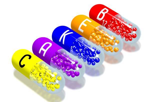 concepto de vitaminas - b, e, k, a, c - capsule vitamin pill letter k medicine fotografías e imágenes de stock
