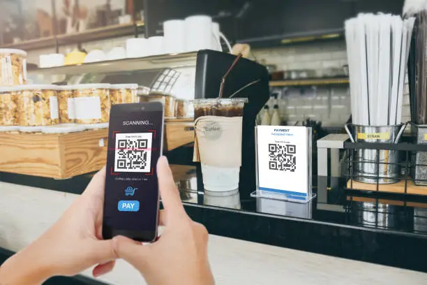 Qr code payment, E wallet , cashless technology concept. Man scaning  tag in Coffee shop accepted generate digital pay without money.Qr code payment, E wallet , cashless technology concept. Man scanning  tag in Coffee shop accepted generate digital pay without money.